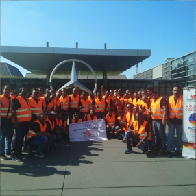 A group of people holding a large banner