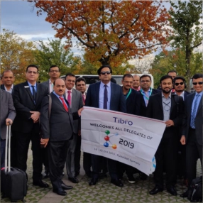 Corporate delegates at the Tibro 2019 event, posing together.