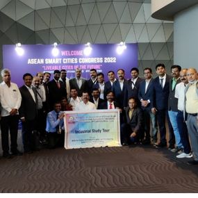 A group of smiling people holding a large check