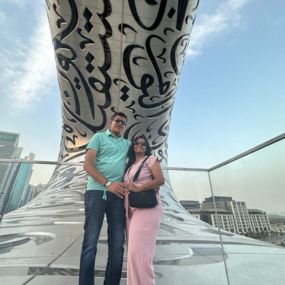 Couple posing in front of the Museum of the Future, Dubai.