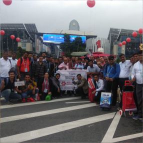 Group of people smiling and posing on a road