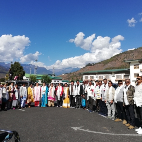 A cheerful group posing with a large ceremonial check