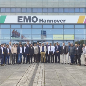 Group of people poses in front of an emo-themed Hanover building.
