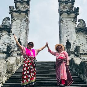 Two women in stand on steps 